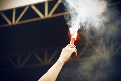 Hand of Man Holding Flare in a Stadium
